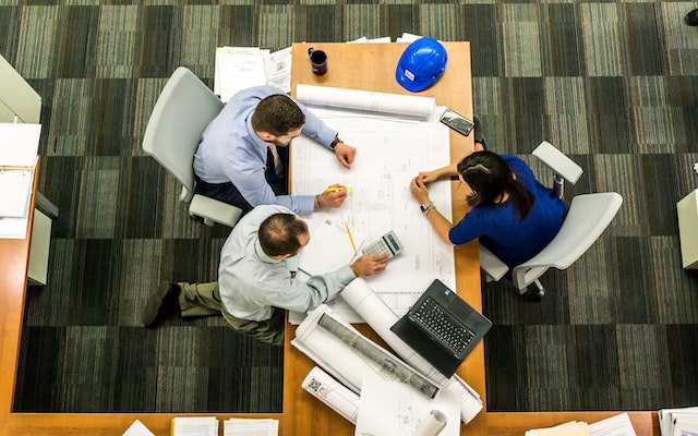 Overhead of three people working in an office